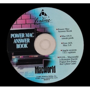 May include: A CD-ROM featuring the America Online logo, the text "Power Mac Answer Book" and "Macworld." Other text includes "Mac OS 8 sneak peek" and "Apple system 7.6.1 update."