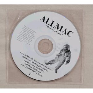 May include: A CD-ROM disc with the text "ALLMAC" and "Power To Crush" printed on it. The disc also features an illustration of a person in a spacesuit. The disc is in a clear plastic sleeve.