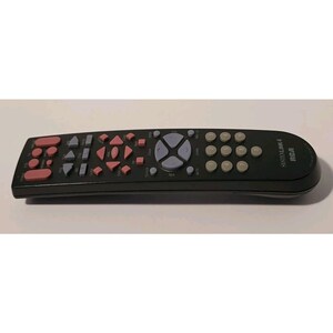 May include: Black RCA Systemlink 4 remote control with pink, gray, and white buttons. The remote has a curved design and features a variety of buttons for controlling a television or other electronic devices. The RCA logo is visible on the side.