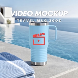 May include: A light blue 20oz travel mug with a handle and a silver rim, featuring a red film clapperboard icon on the front. The text VIDEO MOCKUP TRAVEL MUG 20OZ is displayed above the mug. The mug has a ribbed texture on the lower half.