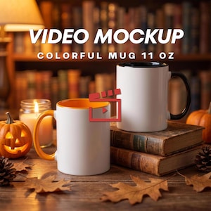 May include: Two 11 oz ceramic mugs, one with an orange handle and interior and one with a black handle and interior, displayed on old books. The text VIDEO MOCKUP COLORFUL MUG 11 OZ is visible at the top. A lit candle and a pumpkin are nearby.