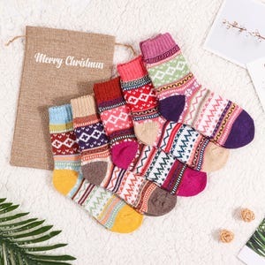 May include: Set of six colourful patterned socks with a festive Christmas theme. The socks are made of a soft, cosy material and are perfect for keeping your feet warm during the winter months.