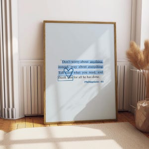 May include: A framed print with a blue and white quote about prayer and gratitude. The quote reads "Don't worry about anything: instead, pray about everything. Tell God what you need, and thank him for all he has done." The quote is attributed to Philippians 46.