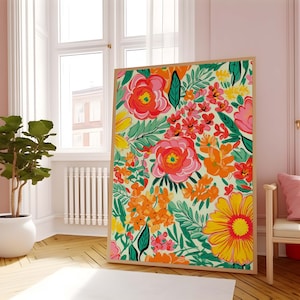 May include: A framed print featuring a colorful floral pattern with pink, red, orange, yellow, and green flowers on a light green background.