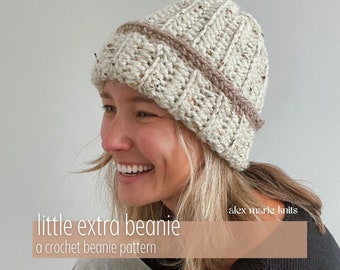 May include: A woman wearing a beige and brown crocheted beanie with the text "little extra beanie" and "a crochet beanie pattern" below. The text "alex marie knits" is in the upper right corner.