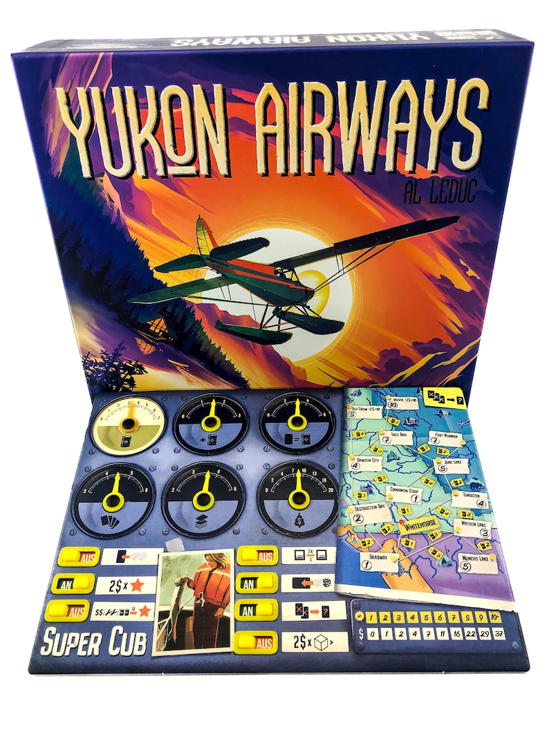 May include: Yukon Airways board game box and game components. The box features a vintage illustration of a seaplane against a sunset. Game components include a game board, dials, and cards. The text "YUKON AIRWAYS" and "SUPER CUB" are visible.