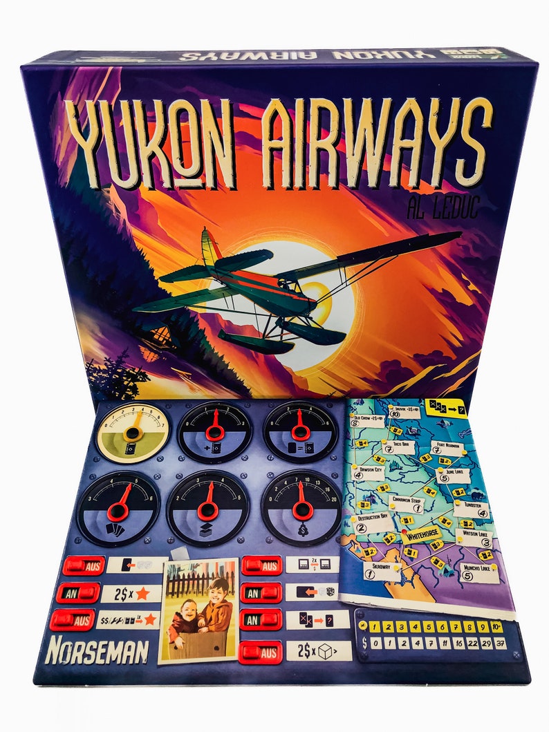May include: A board game box titled "Yukon Airways" with a vintage airplane illustration against a sunset backdrop. The game includes a control panel with gauges, a map, and game pieces. The word "Norseman" is visible.