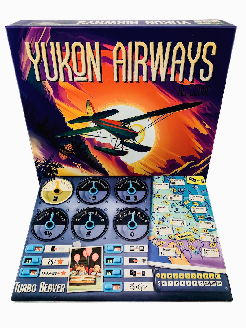 May include: A board game box titled "Yukon Airways" with a colorful illustration of a seaplane flying in front of a sunset. The game includes a control panel, map, and game pieces. The text "Turbo Beaver" is visible.