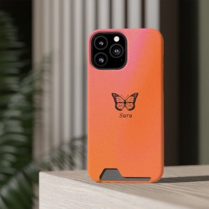 May include: Orange phone case with a black butterfly design and the name "Sara" printed on it.