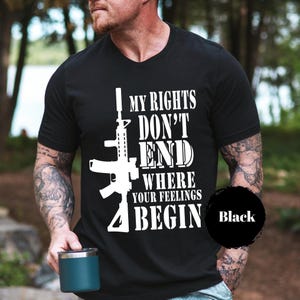 May include: Black V-neck t-shirt with a white rifle graphic and the text "MY RIGHTS DON'T END WHERE YOUR FEELINGS BEGIN". The word "Black" is in a black circle on the bottom right.