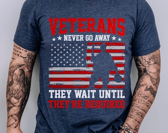 May include: A navy blue t-shirt with a distressed American flag design and the text "Veterans Never Go Away They Wait Until They're Required".