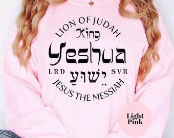 May include: Pink sweatshirt with a black circle graphic that says "Lion of Judah King Yeshua LRD Y'shua SVR Jesus the Messiah".