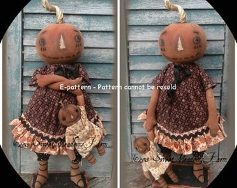 May include: Two handmade pumpkin dolls with brown and white patterned dresses. The dolls are holding smaller pumpkin dolls. The dolls are standing on a wooden base. E-pattern - Pattern cannot be resold. 2015 Sweet Meadows Farm.