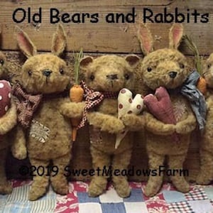 May include: Five handmade plush toys, including three brown rabbits and two brown bears, holding hearts and carrots. The rabbits have long ears and are wearing fabric bows. The bears have button eyes and are wearing fabric bows. The toys are sitting on a red and white checkered fabric. The text "Old Bears and Rabbits" is at the top of the image. The text "2019 Sweet Meadows Farm" is at the bottom of the image.