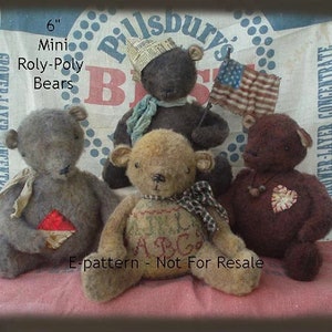 May include: Four handmade 6-inch mini roly-poly bears. The bears are made of brown, gray, and tan fabric. They are sitting on a pink fabric surface. The bears are wearing different outfits, including a blue scarf, a plaid bow, and a heart-shaped patch. The image includes the text "6" Mini Roly-Poly Bears" and "E-pattern - Not For Resale".