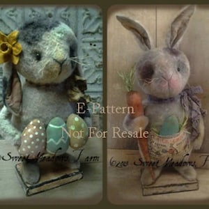 May include: Two handmade primitive style Easter bunny figurines. One is a gray bunny holding a basket of colorful eggs. The other is a white bunny holding a carrot and a basket of eggs. Both bunnies are standing on wooden bases. The text "E-Pattern Not For Resale" is visible on the image.