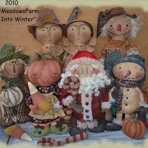 May include: A group of handmade rag dolls dressed in fall and winter themes. The dolls include a scarecrow, a pumpkin, a Santa Claus, a snowman, and two other dolls. The dolls are all standing on a wooden surface. The text "SweetMeadowsFarm" and "Fall Into Winter" is visible in the image.