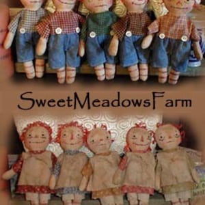 May include: A collection of handmade rag dolls with red yarn hair and painted faces. The dolls are wearing various outfits, including plaid shirts, denim pants, and dresses. The dolls are arranged in two rows, with the top row featuring dolls with white caps and the bottom row featuring dolls with red yarn hair.