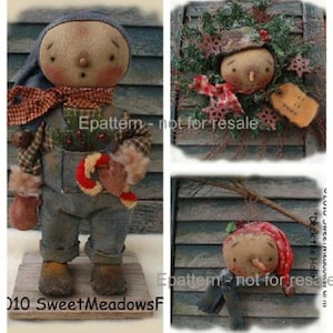 May include: Three handmade rag doll ornaments with a winter theme. The first doll is wearing overalls and holding a candy cane. The second doll is wearing a red and white hat and is part of a wreath. The third doll is wearing a red hat and scarf and is holding a stick.