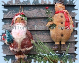 May include: A handmade felt Santa Claus ornament with a red hat, white beard, and brown coat. He is holding a small green tree and a candy cane. A snowman ornament with a red scarf and black hat is also pictured. The ornaments are displayed against a rustic wooden background.