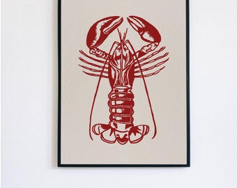 May include: A red lobster illustration in a black frame. The lobster is depicted in a vintage style with detailed claws and body.