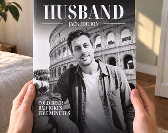 May include: A book titled HUSBAND JACK EDITION featuring a black and white photograph of a person in front of the Colosseum. The cover text reads COLD BEER BAD JOKES FIVE MINUTES. The book is held by two hands against a blurred indoor background.