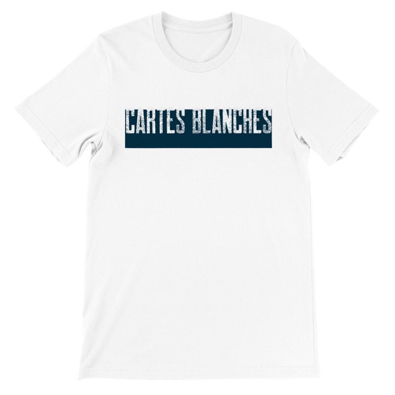 May include: White short sleeve t-shirt featuring a navy blue horizontal banner with the text 'CARTES BLANCHES' in a distressed, vintage-style font. The shirt is a classic crew neck style and appears to be made of a soft, comfortable cotton material.  The overall design is simple and minimalist, ideal for casual wear.