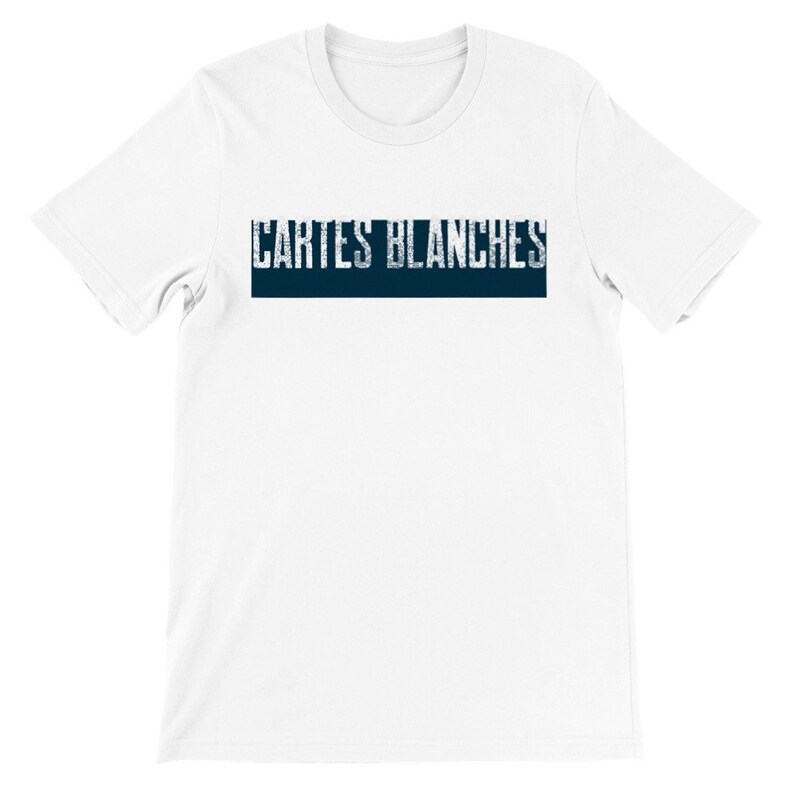 May include: White short sleeve t-shirt featuring a navy blue horizontal band with the text 'CARTES BLANCHES' in a distressed, vintage-style font. The shirt is a classic crew neck style and appears to be made of a soft, comfortable cotton material.  The overall design is simple and minimalist, suitable for casual wear.
