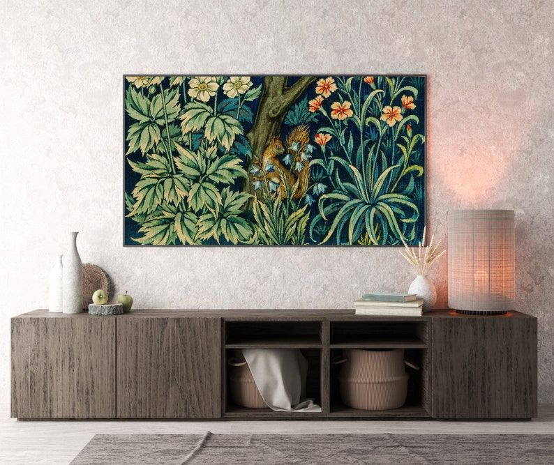 May include: A dark wood media console with three shelves, a tapestry with a floral and animal design hanging above it, and a lamp with a beige shade on the right side.