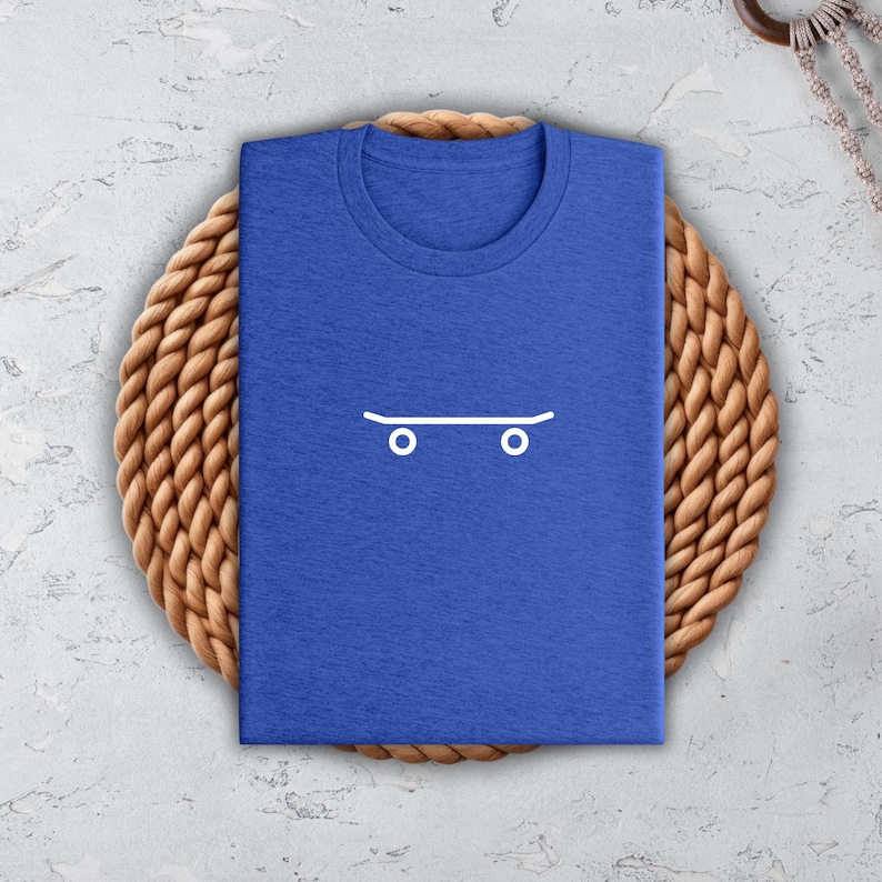 a blue t - shirt with a skateboard drawn on it