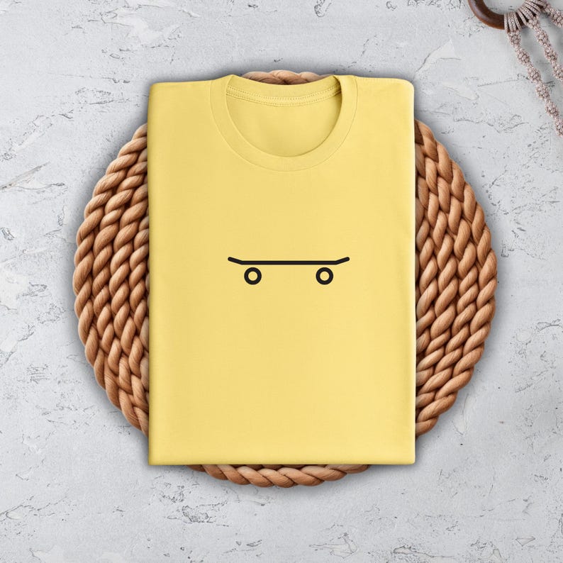 a yellow shirt with a skateboard drawn on it