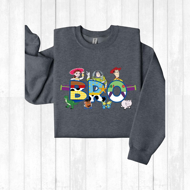 a child's long sleeved shirt with cartoon characters on it