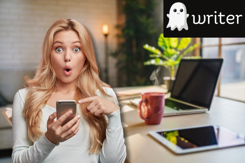 May include: A woman with blonde hair looks surprised while holding a silver smartphone. She is pointing at the phone with her right index finger. The background is blurred and shows a laptop, a mug, and a tablet.