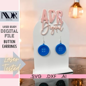 May include: A pair of blue button earrings on a white display stand. The earrings are laser cut and ready to be made into jewelry. The image also includes the text "Laser Ready Digital File Button Earrings Laser Tested .SVG .DXF .AI"