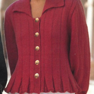 May include: A red knitted cardigan with a collared neckline and a button-up front. The cardigan has a fitted bodice and a flared hem.
