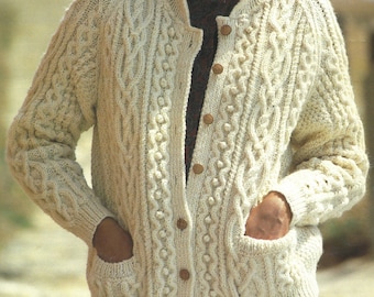 May include: A cream-colored knitted cardigan with a cable knit pattern and wooden buttons. The cardigan has two pockets.