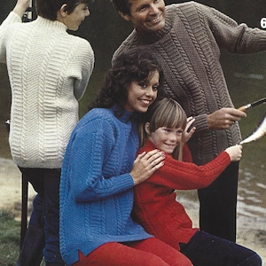 May include: A family of four wearing knitted sweaters. The sweaters are in various colors, including white, blue, red, and brown. The sweaters feature a cable knit pattern. The family is standing near a body of water.
