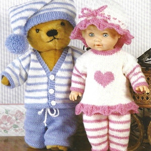 May include: A knitted doll outfit with a pink and white striped pattern and a pink heart on the front. The doll is wearing a matching pink and white striped hat. A teddy bear is wearing a blue and white striped knitted outfit with a blue knitted hat.