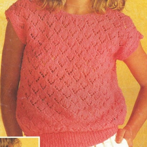 May include: A pink crocheted top with a diamond pattern and short sleeves.