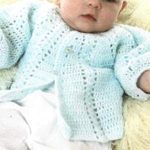 May include: A light blue crocheted baby cardigan with a button closure.