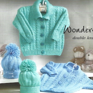 Può includere: Due cardigan in maglia per neonati, uno blu e uno verde, con cappellini abbinati. I cardigan hanno una chiusura con bottoni e un colletto. I cappellini hanno un pon pon sulla cima. "Wonder double knit" è scritto sull'immagine.