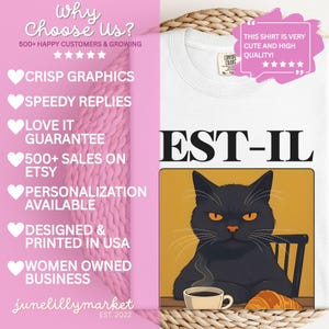 May include: White t-shirt with a graphic of a black cat sitting at a table with a cup of coffee and a croissant. The text "EST-IL" is above the cat. The shirt has a Comfort Colors tag.