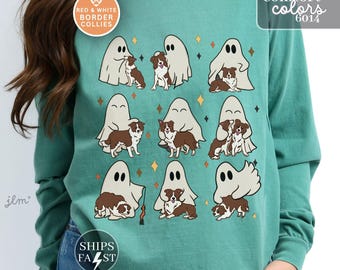 May include: A teal long-sleeve crewneck sweatshirt featuring a graphic print of nine white ghosts interacting with brown and white Border Collie dogs, accented by small orange and black four-pointed stars scattered across the front of the garment.