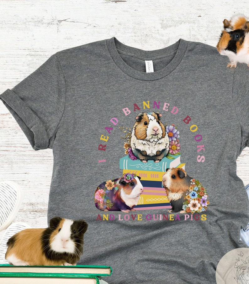 May include: Gray t-shirt with a graphic of three guinea pigs on a stack of books. The text around the guinea pigs reads "I read banned books and love guinea pigs".