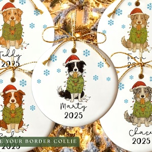 May include: White ceramic Christmas ornaments featuring illustrated dogs wearing Santa hats and sweaters. Each ornament has a different dog breed, name, and the year 2025. Blue snowflakes and gold string complete the festive design.