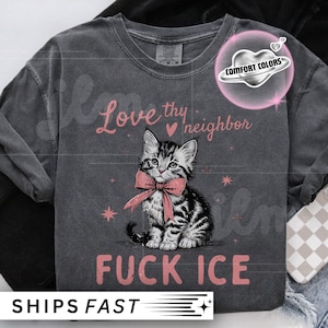 May include: Dark gray t-shirt with a graphic of a kitten wearing a pink bow tie. The text "Love thy neighbor" and "FUCK ICE" are printed in pink. The shirt also has the Comfort Colors logo.