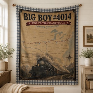 May include: A rectangular wall tapestry featuring a vintage-style map of the United States with a steam locomotive at the bottom. The text reads Big Boy #4014 Coast-to-Coast Tour Celebrating America's 250th. It has a blue and white plaid border.