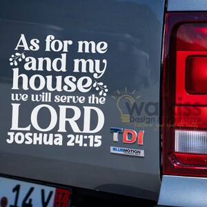 Puede incluir: Calcomanía de vinilo blanco sobre un vehículo gris. La calcomanía dice: "En cuanto a mí y a mi casa, serviremos al SEÑOR, Josué 24:15". También se ve un logotipo y la palabra "TDI".