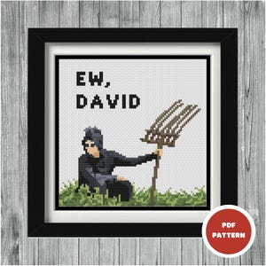 May include: Cross stitch pattern featuring a person holding a pitchfork with the text "EW, DAVID" above them.