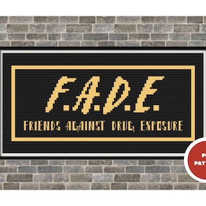 May include: A framed cross-stitch design with the text "F.A.D.E. FRIENDS AGAINST DRUG EXPOSURE" in gold on a black background. The design is set against a brick wall, with a red "PDF PATTERN" button in the lower right corner.